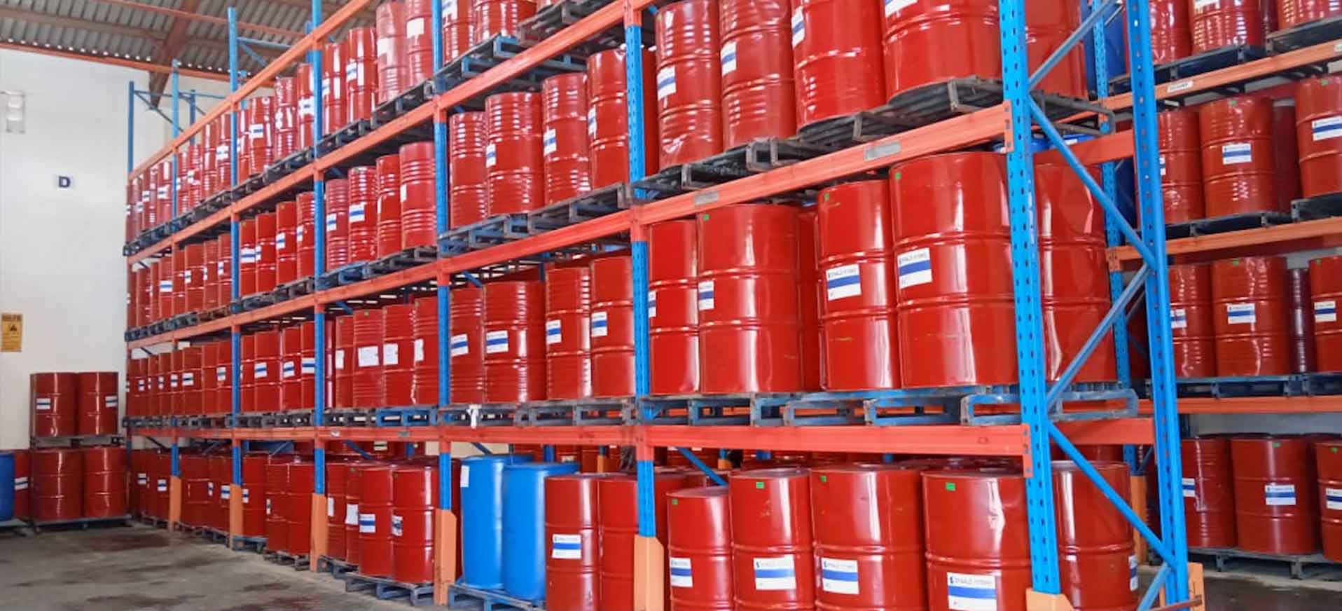 Safe and Secure Storage Solutions Red container drums stacked in a warehouse with the title