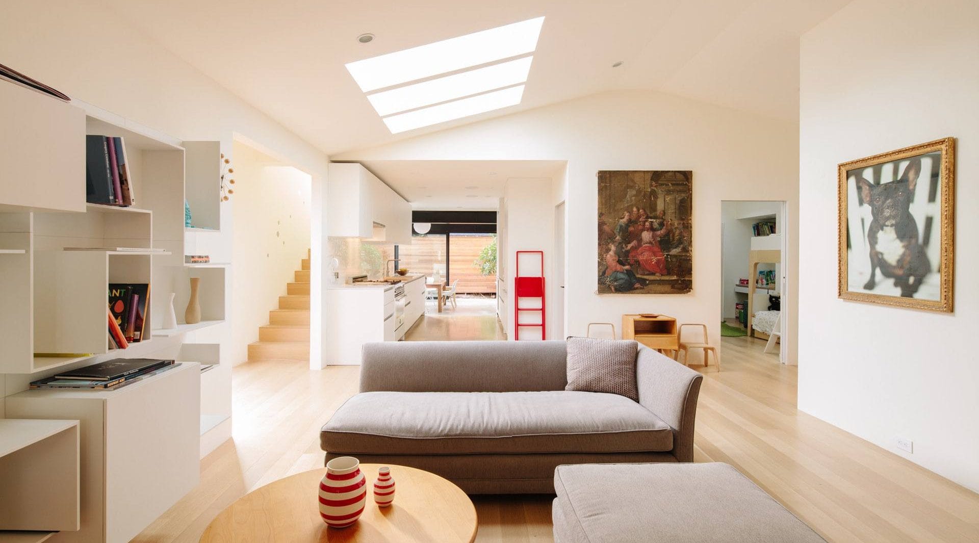 Bright modern residential living room with skylights and contemporary decor.