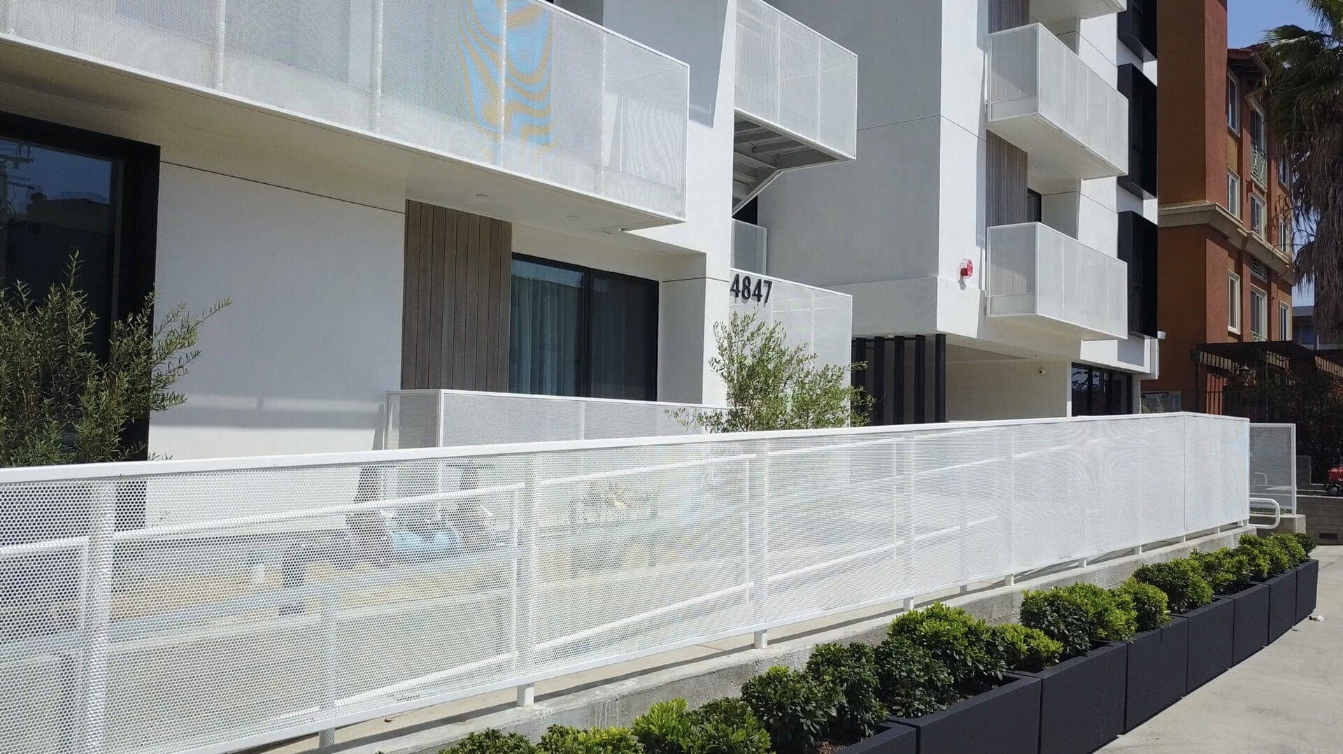 Modern multi-family residential building with contemporary design and outdoor balconies.