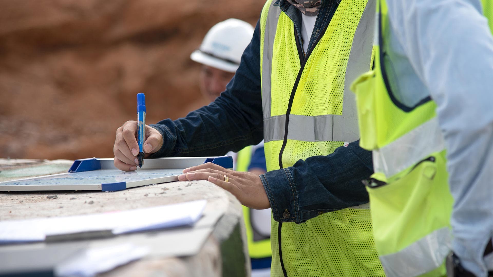 Construction commissioning engineer reviewing site plans during building project