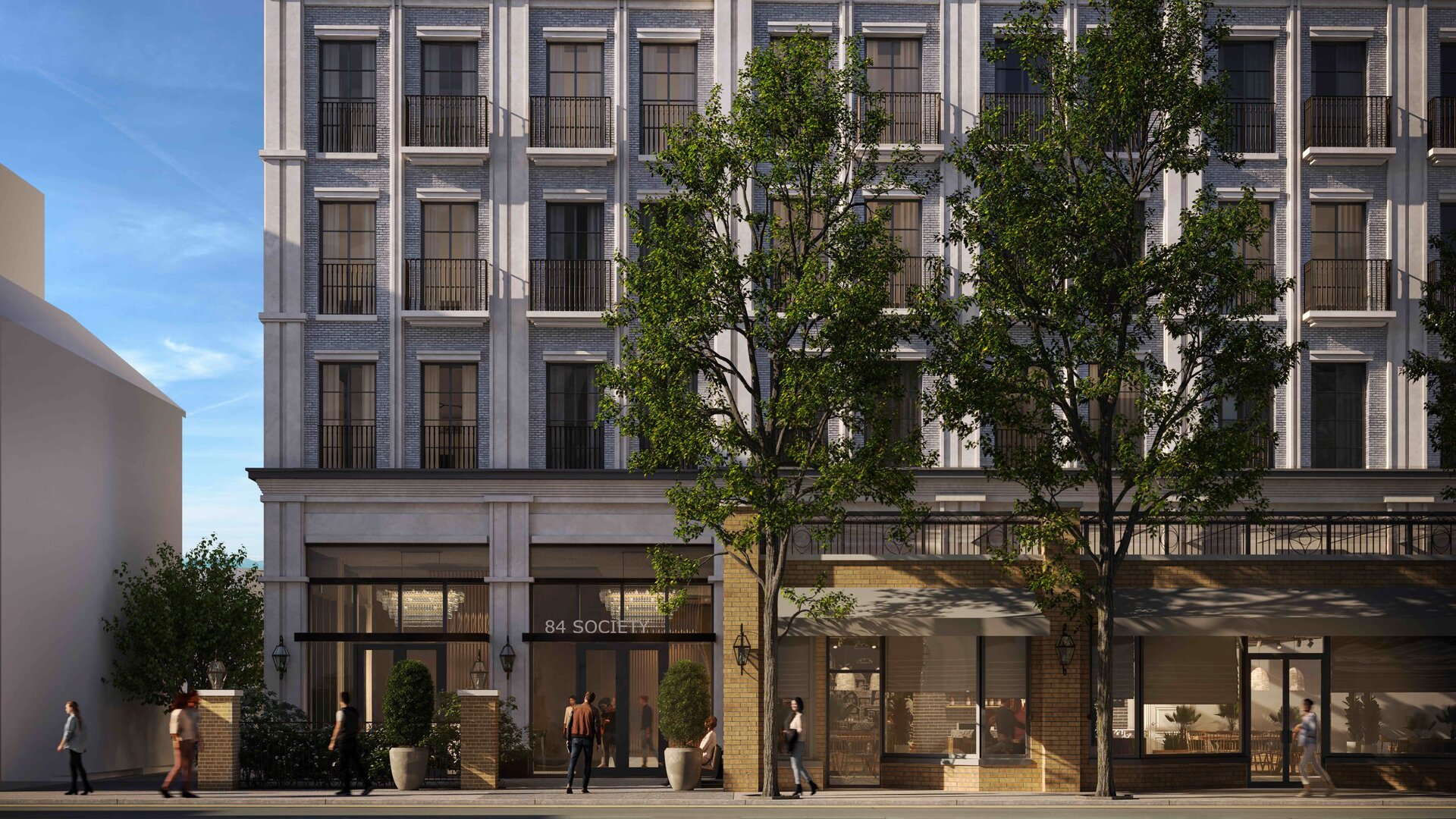 Modern mixed-use building with retail space on the ground floor and residential apartments above.