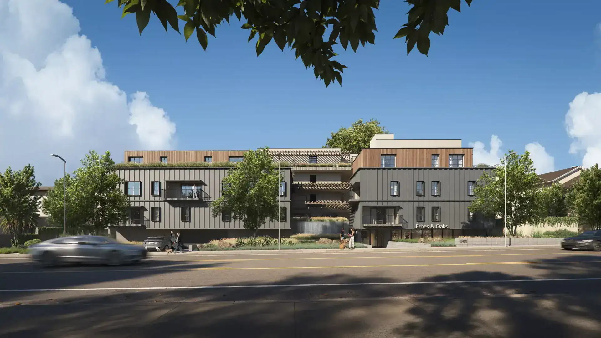 Contemporary multi-story building with a mix of wood and metal paneling, featuring staggered balconies and rooftop greenery.