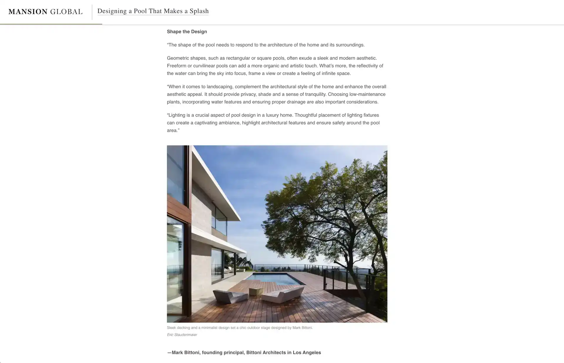 Contemporary modern house with large glass windows, minimalist wooden deck, and a sleek pool area under a blue sky.