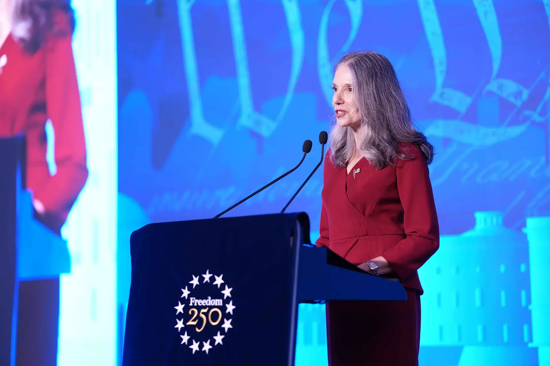 Julie Eadeh giving speech in America 250th anniversary 