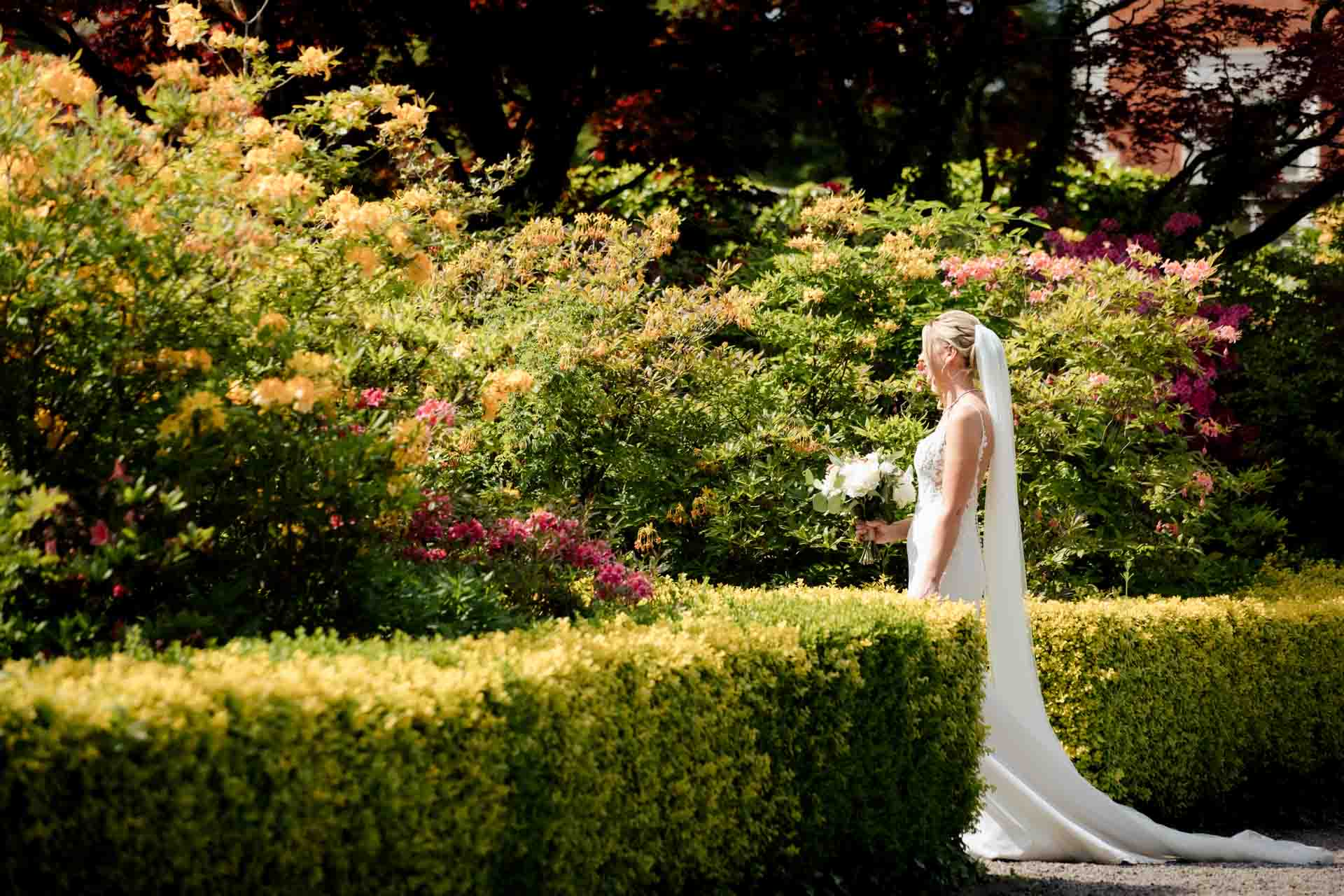 bride and groom portraits in the gardens at eaves hall lancashire