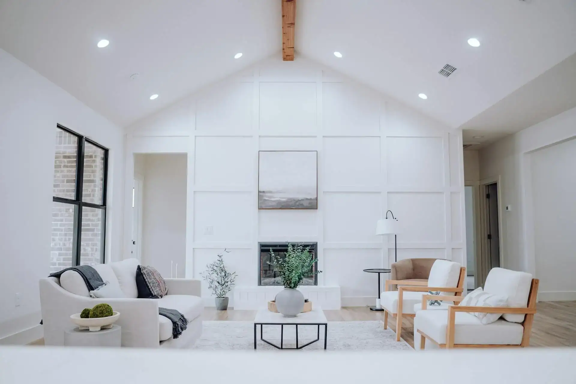 Bright modern living room with vaulted ceiling and fireplace, home renovation trends 2026