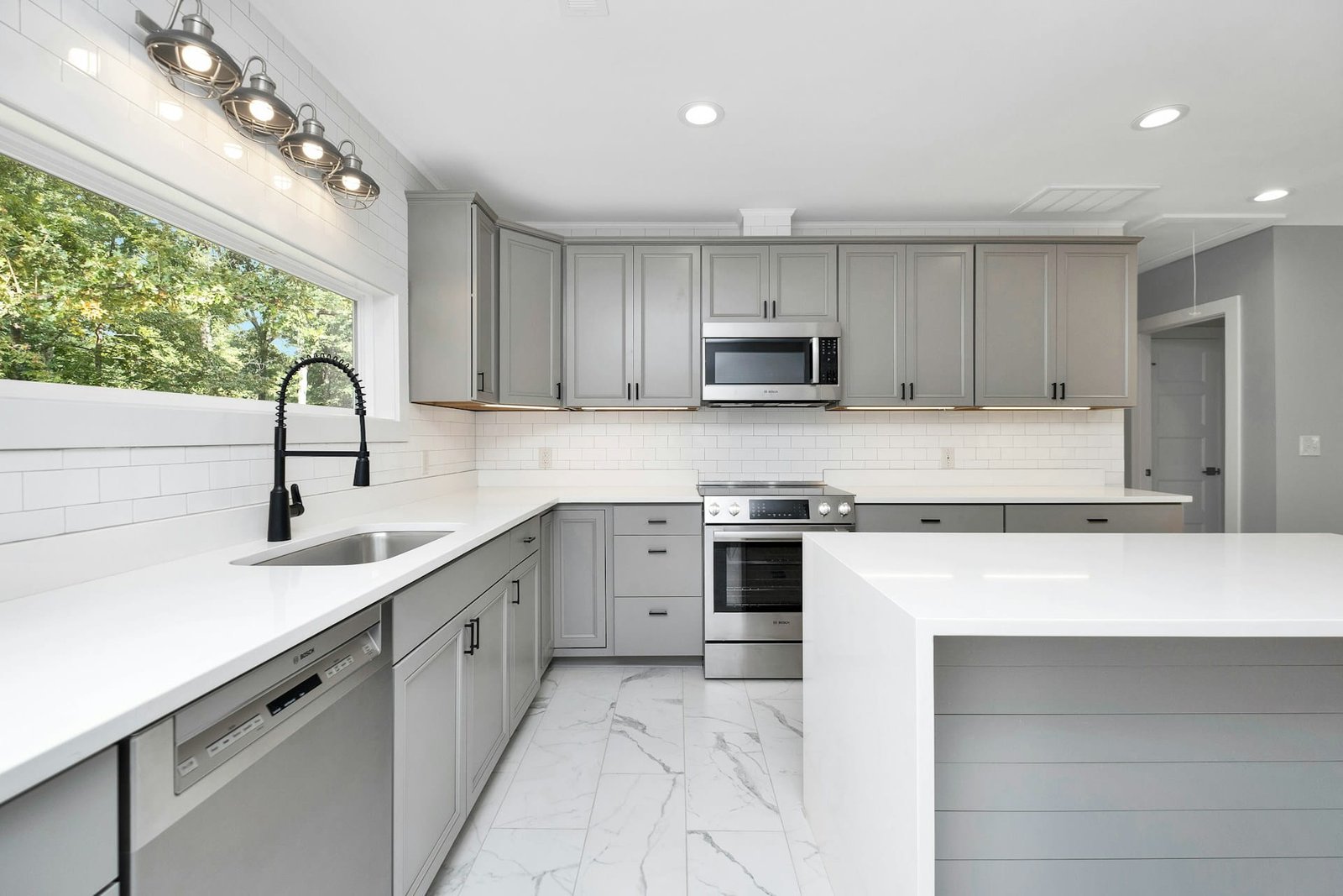 Butcher block vs quartz countertops comparison in a modern kitchen
