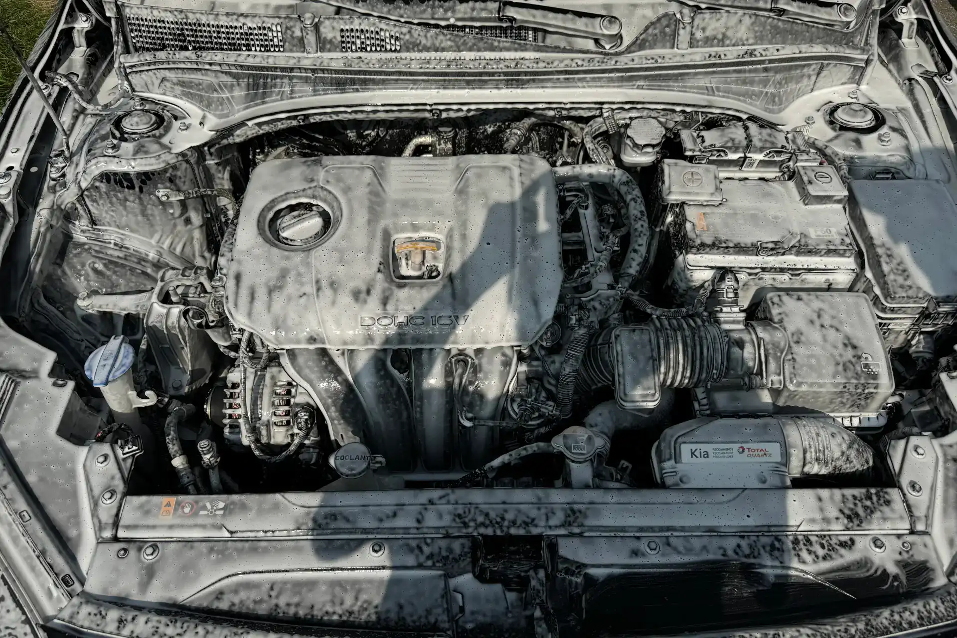 Engine bay being foamed during mid engine bay detail