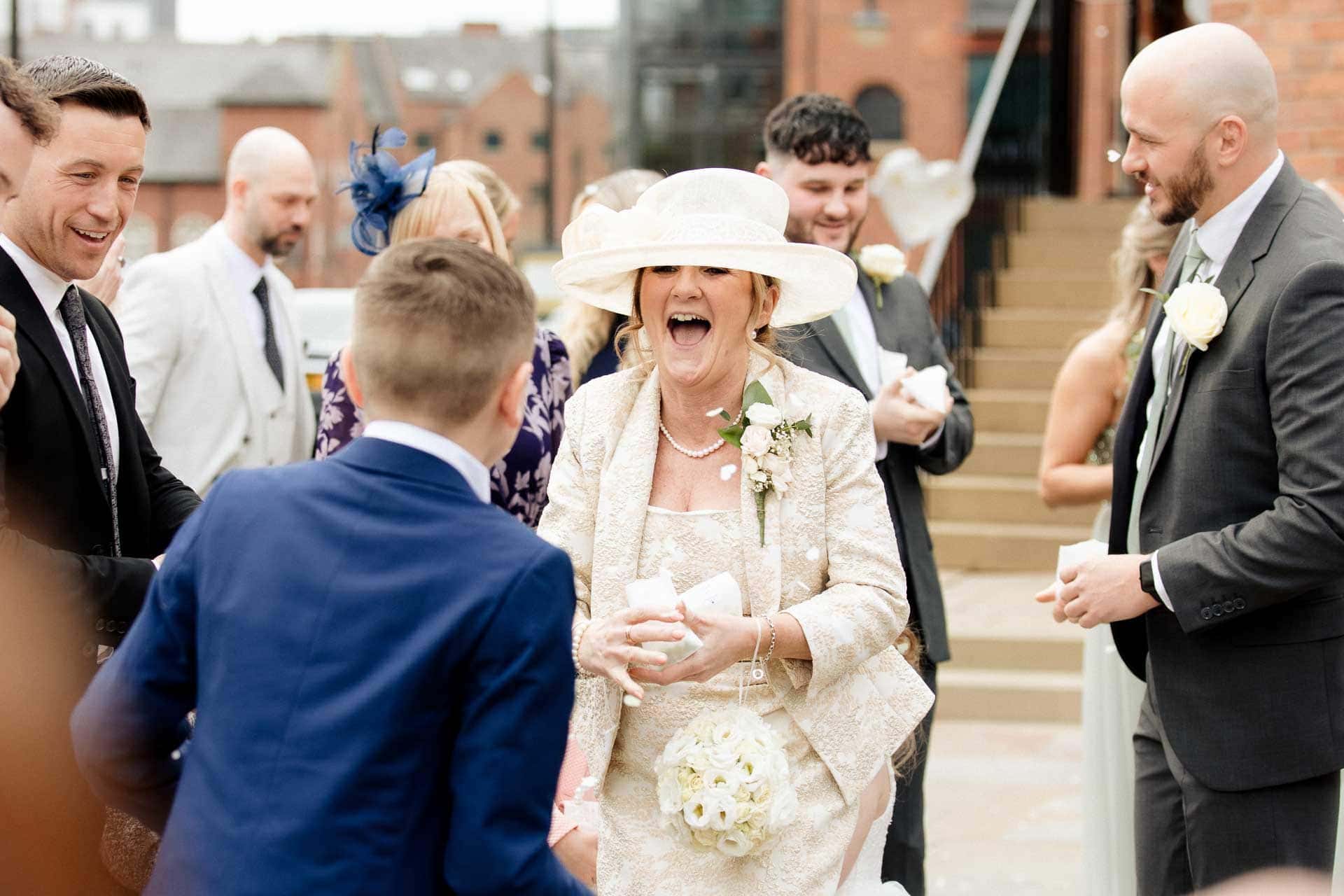 outside the castlefield rooms wedding venue guests gather for group photos