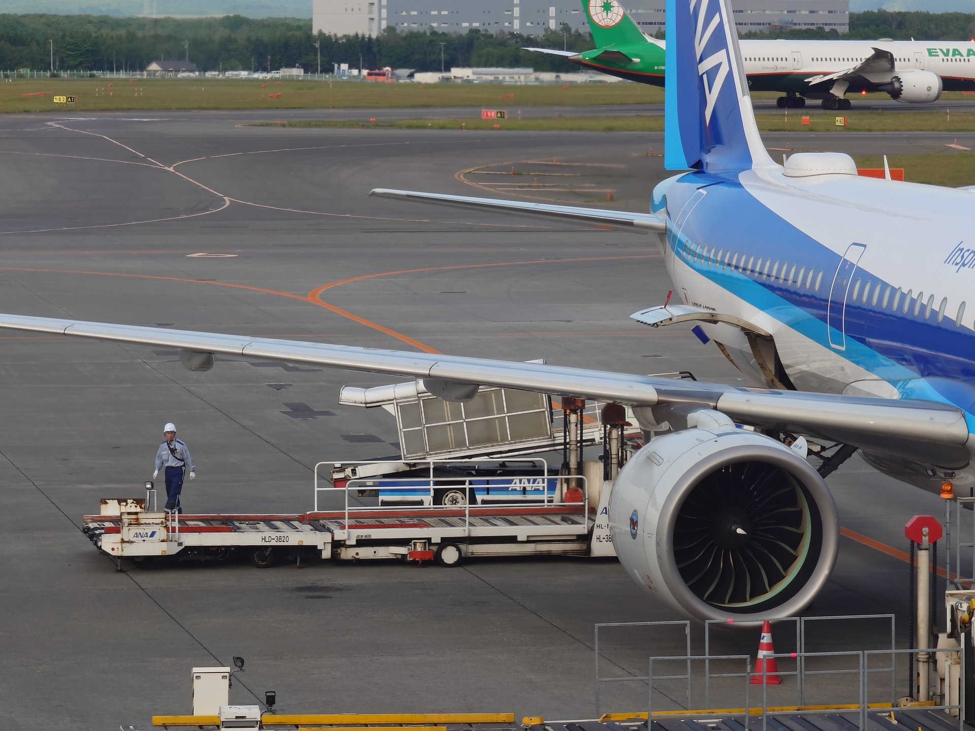 ANA機エンジンそばで作業するグランドスタッフ