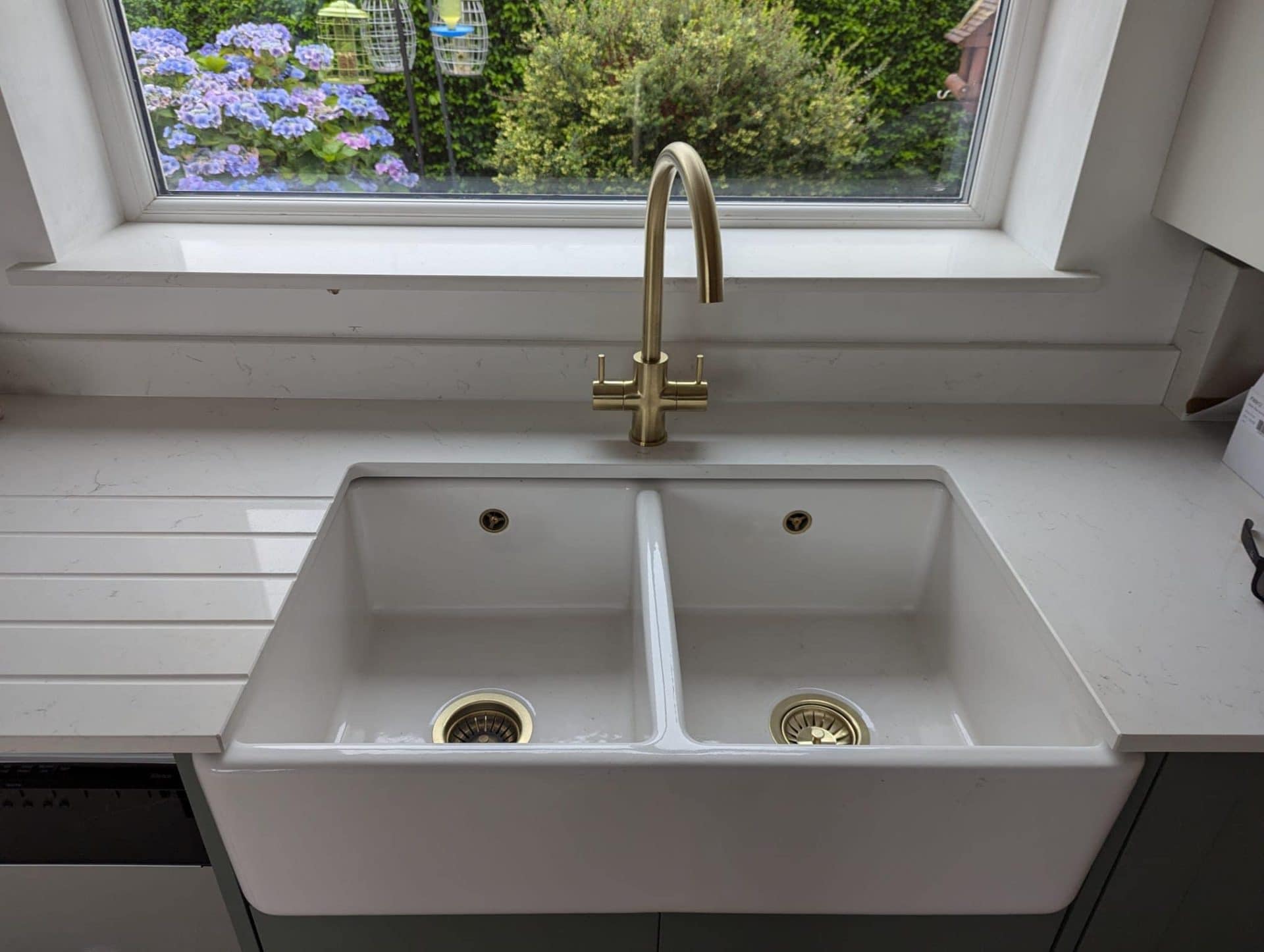 Belfast sink with a stylish brushed brass tap installed in a Giffnock home, combining classic and modern design.