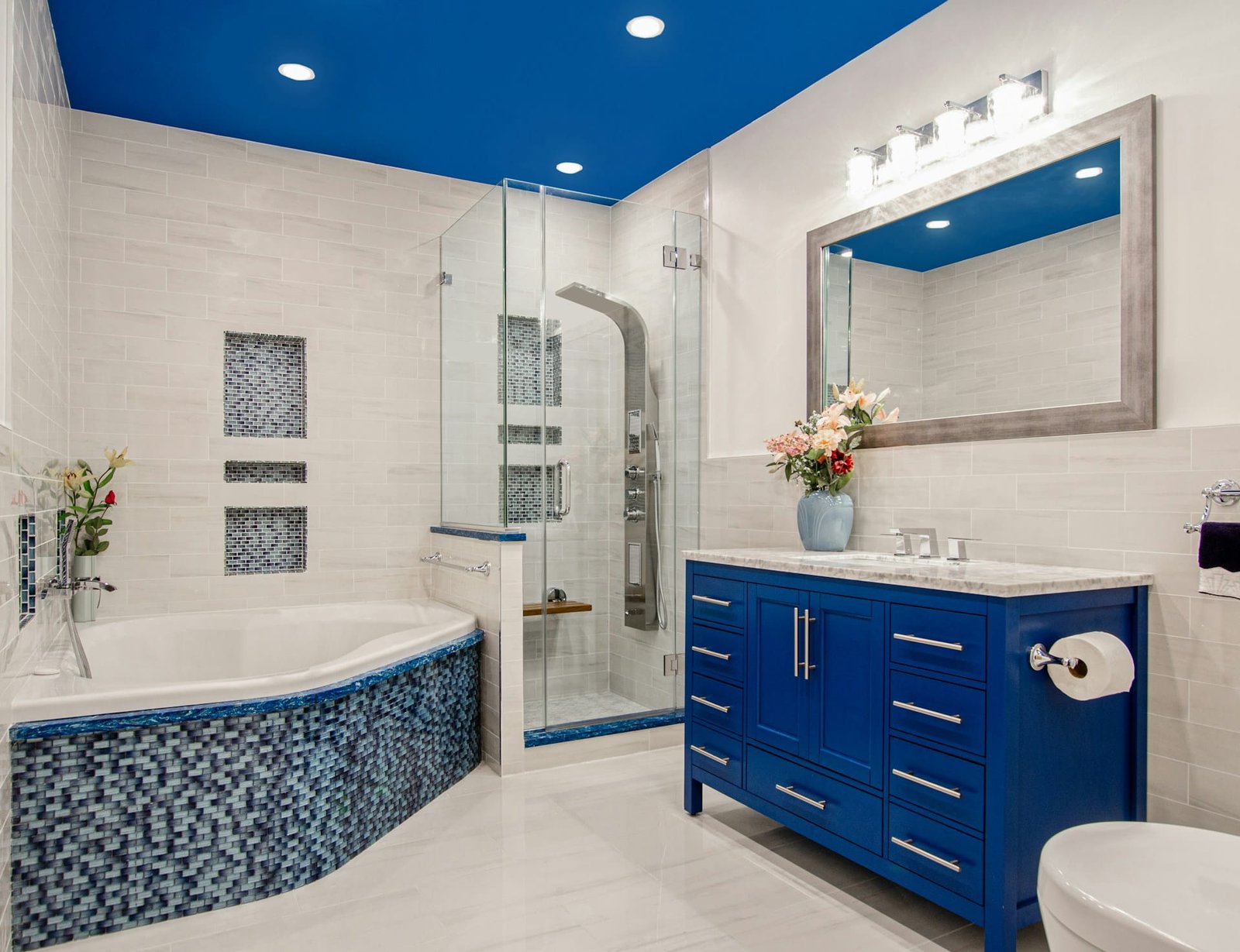 Blue vanity bathroom with walk-in shower, example of 5x10 bathroom remodel cost in 2026