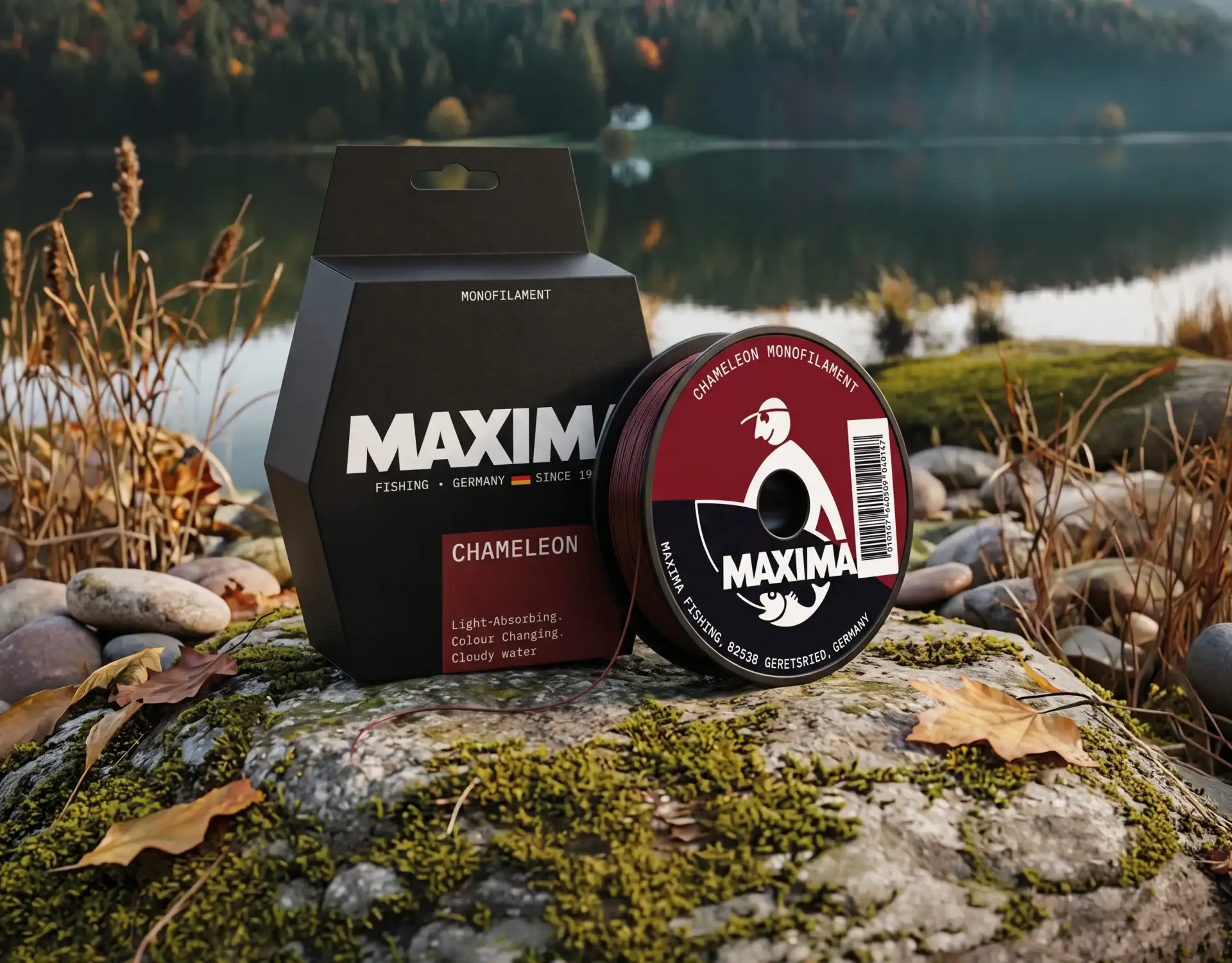 Maxima Chameleon monofilament fishing line spool and dark box by an autumn lake at dusk
