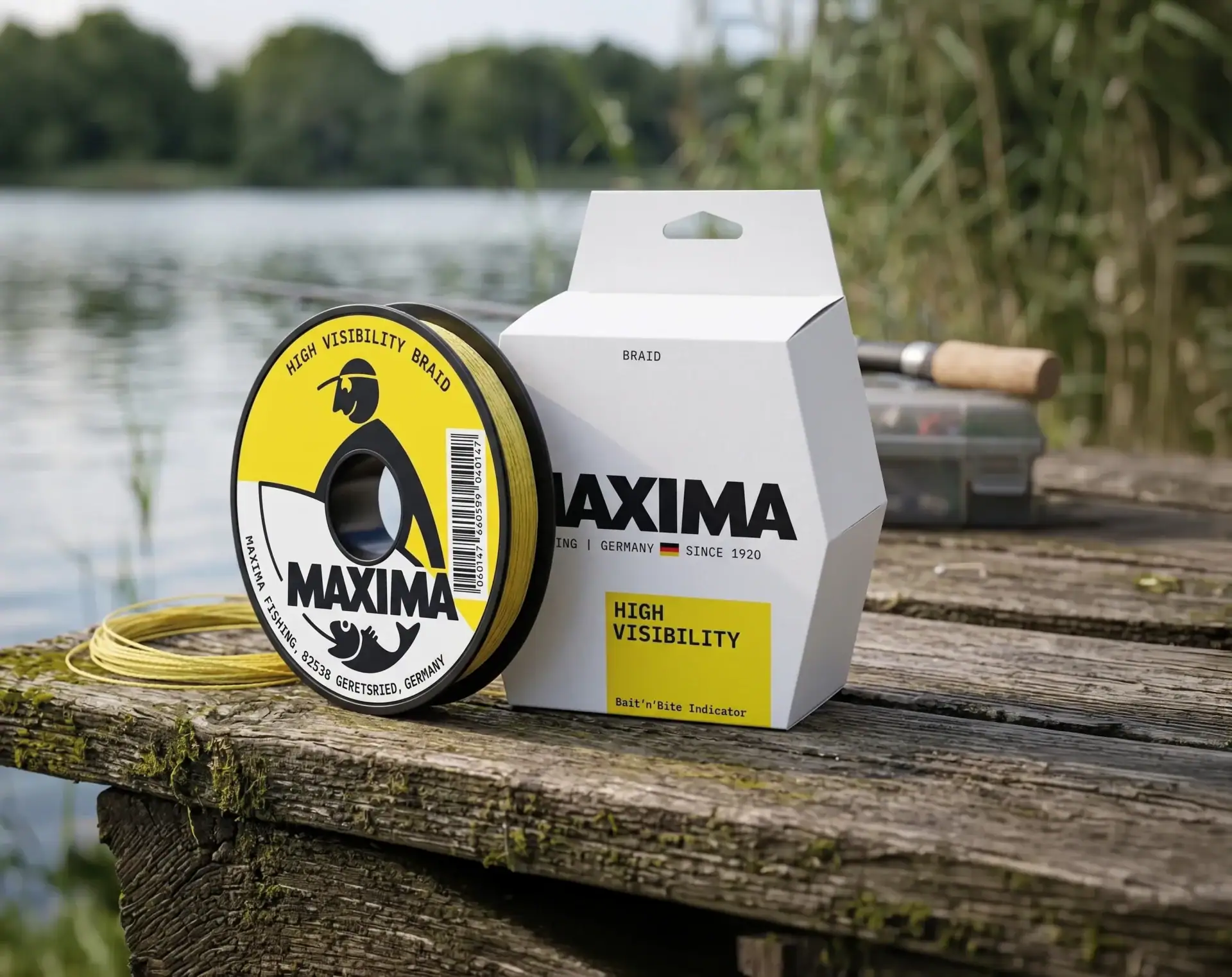 Maxima High Visibility yellow braid fishing line spool and box on wood beside a lake with a rod