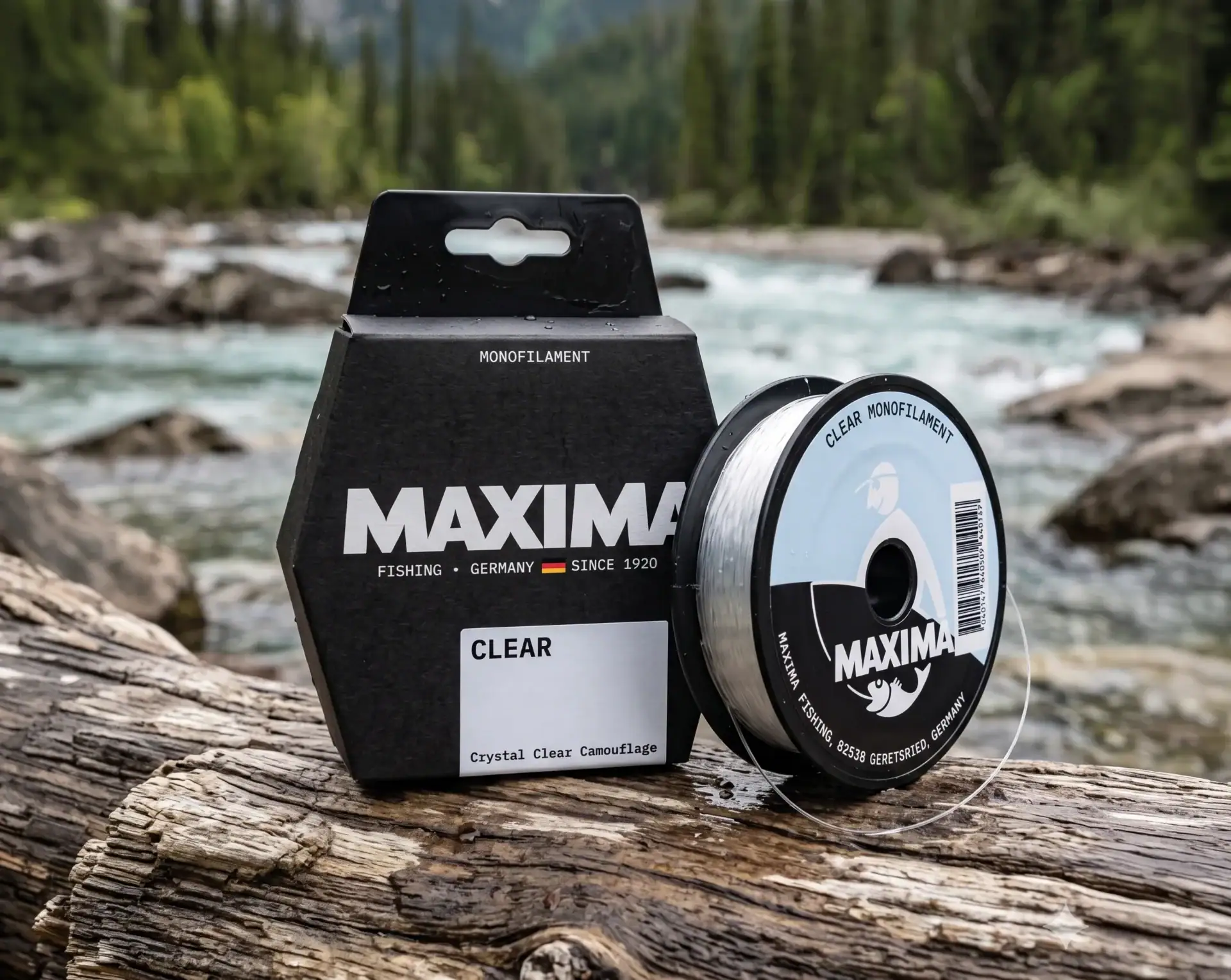Maxima Clear monofilament fishing line spool and box on driftwood beside a flowing river