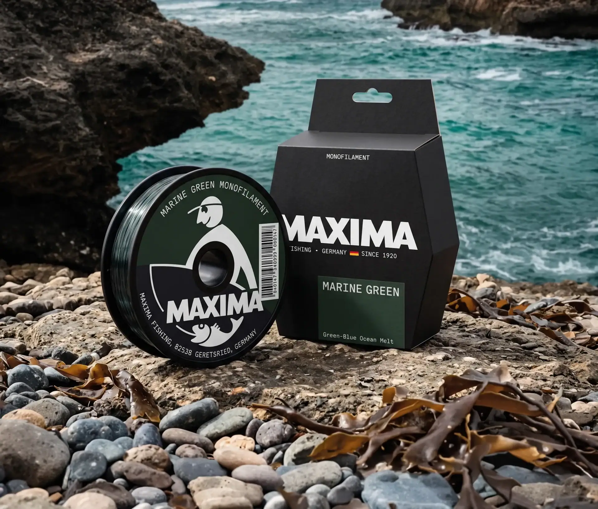 Maxima Marine Green monofilament fishing line spool and box on a rocky coast beneath cliffs