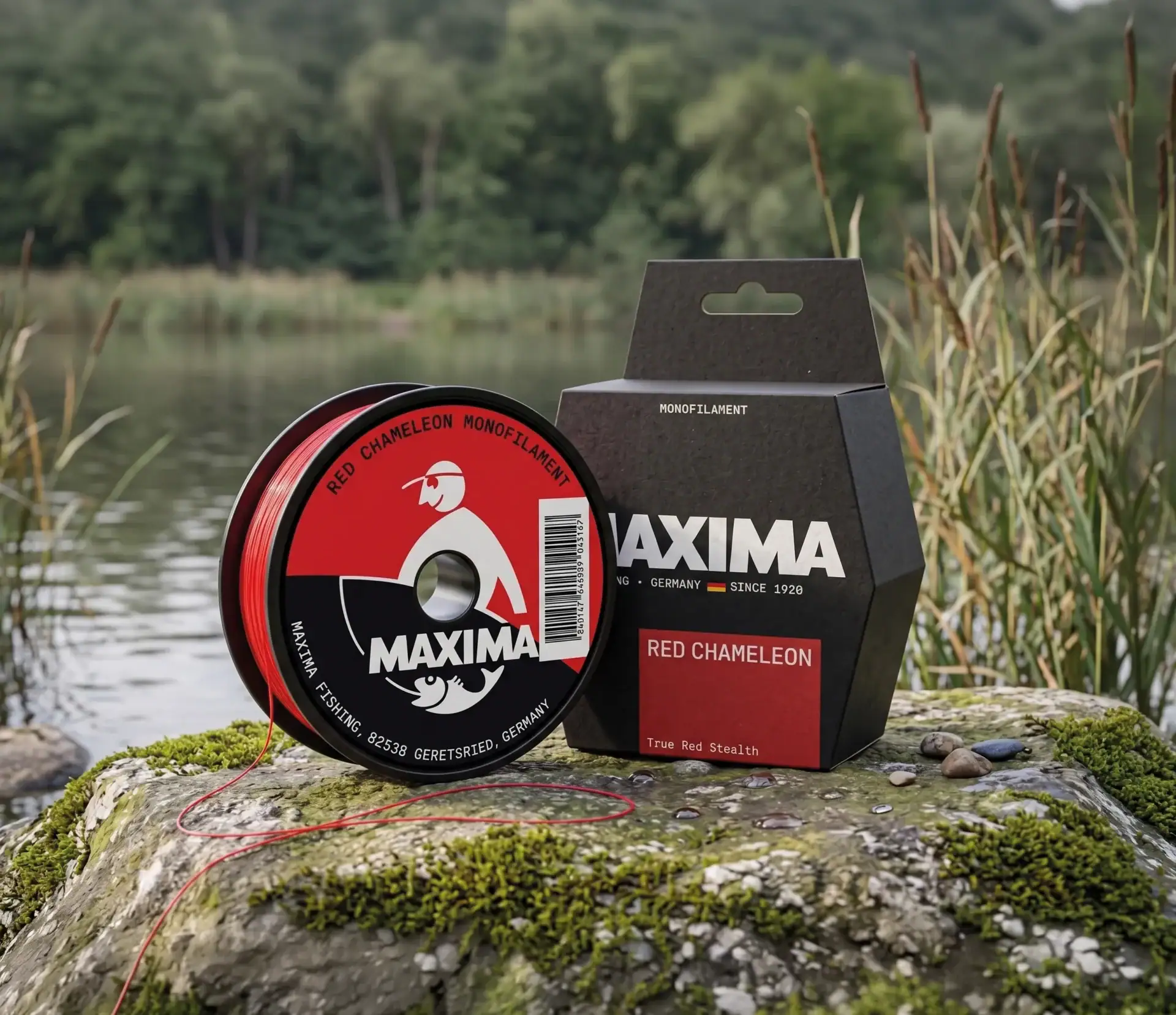 Maxima Red Chameleon monofilament fishing line red spool and dark box on a rock by a lake