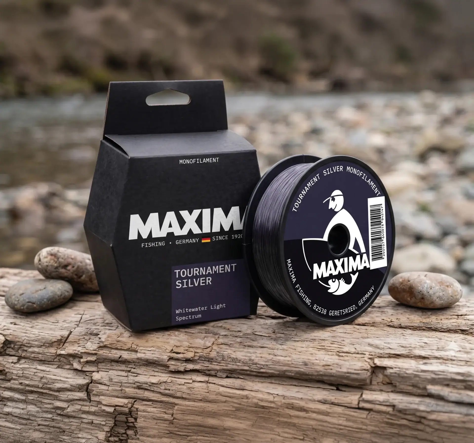 Maxima Tournament Silver monofilament fishing line spool and dark box on wood beside water