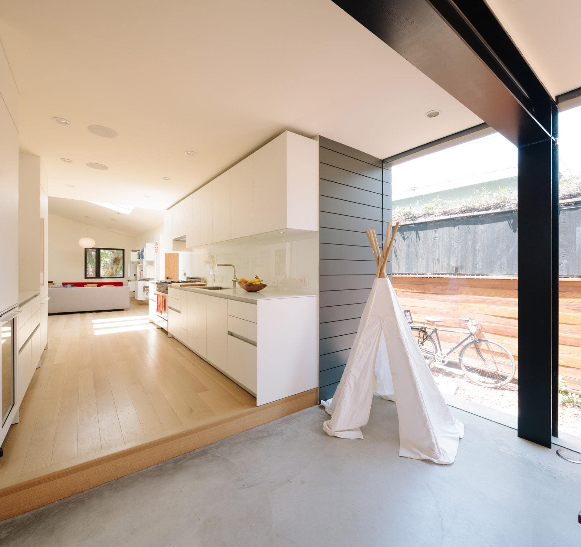 Modern residential interior kitchen with open-plan living space.