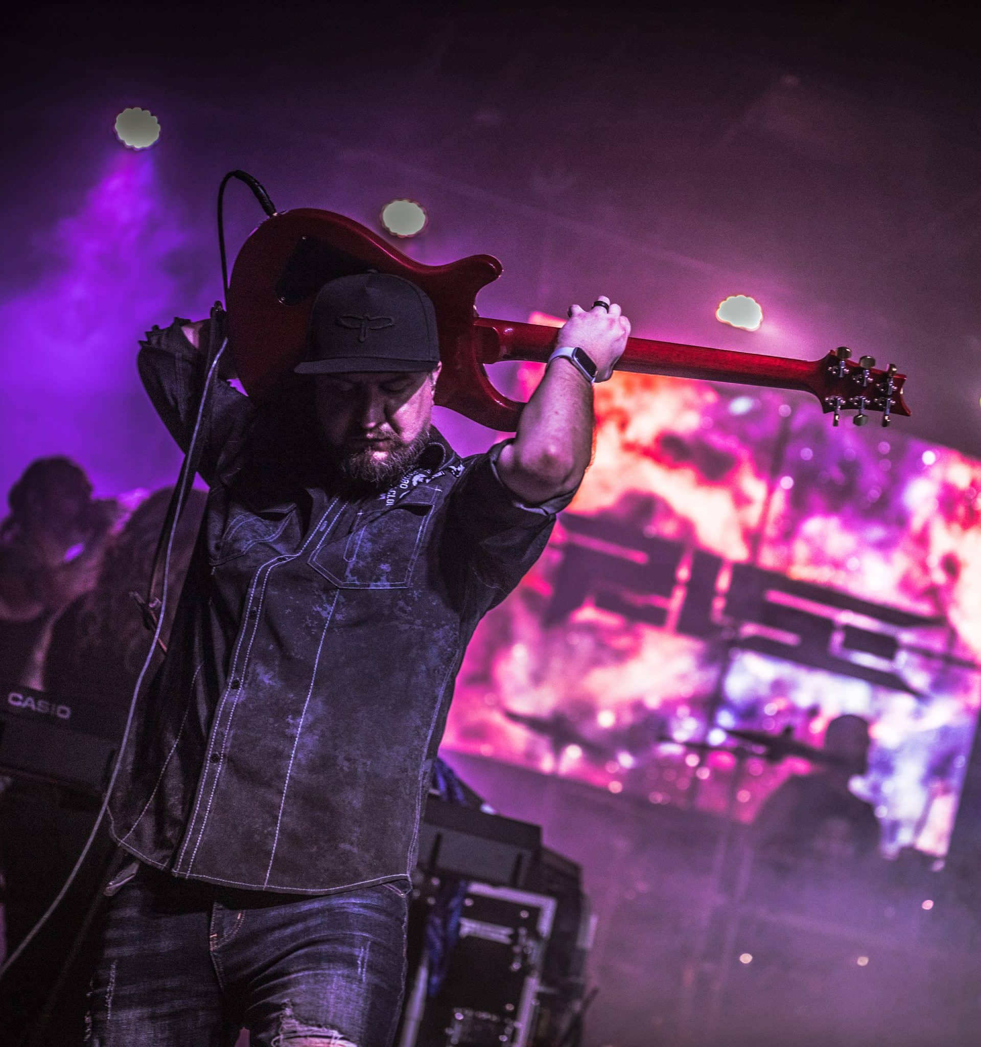 James Brennaman plays a solo behind his head, 2024, Rail Club - Photo by Kimbrel Studios
