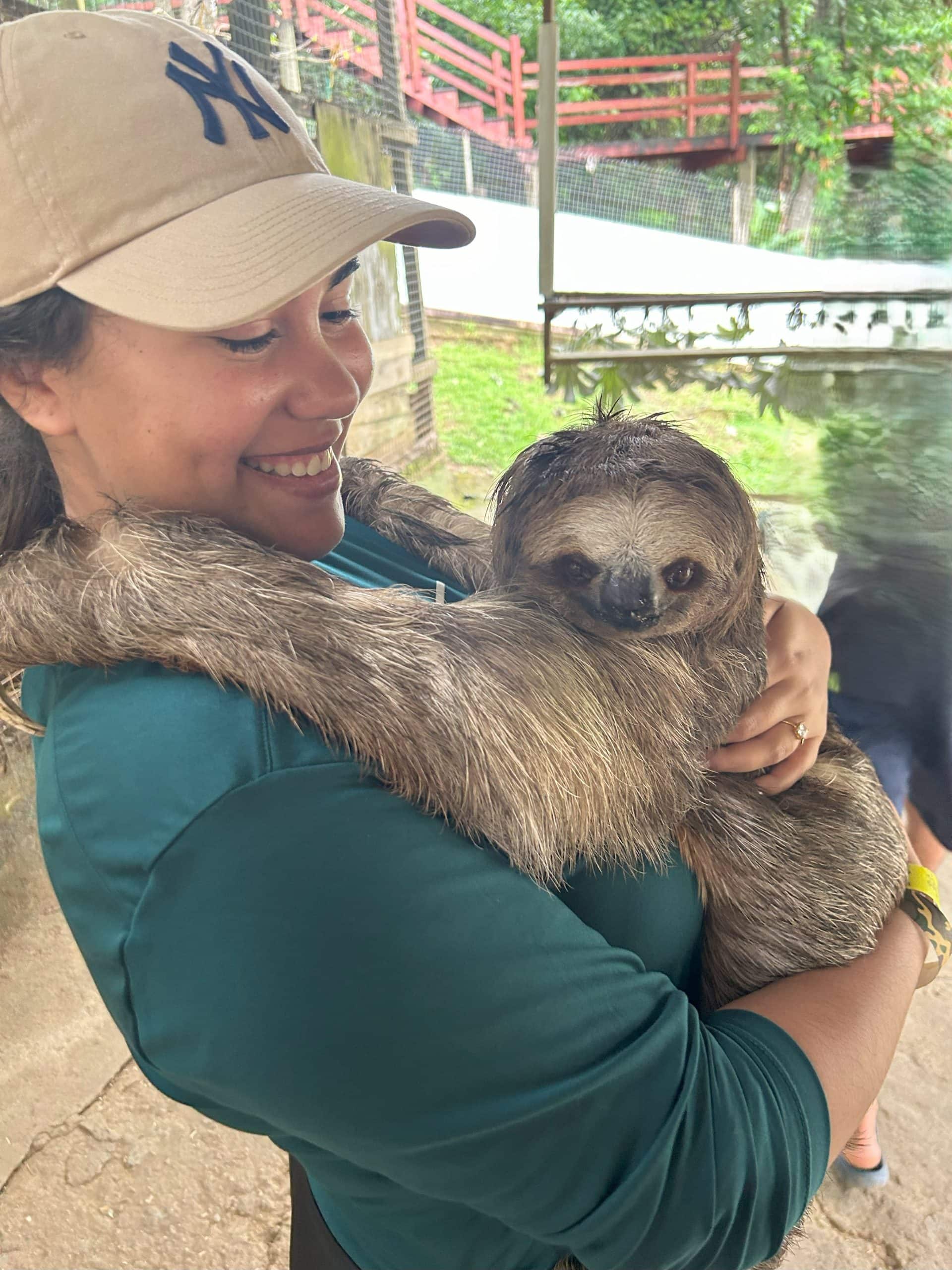 Saleiya Lowery Travel Agent with a sloth