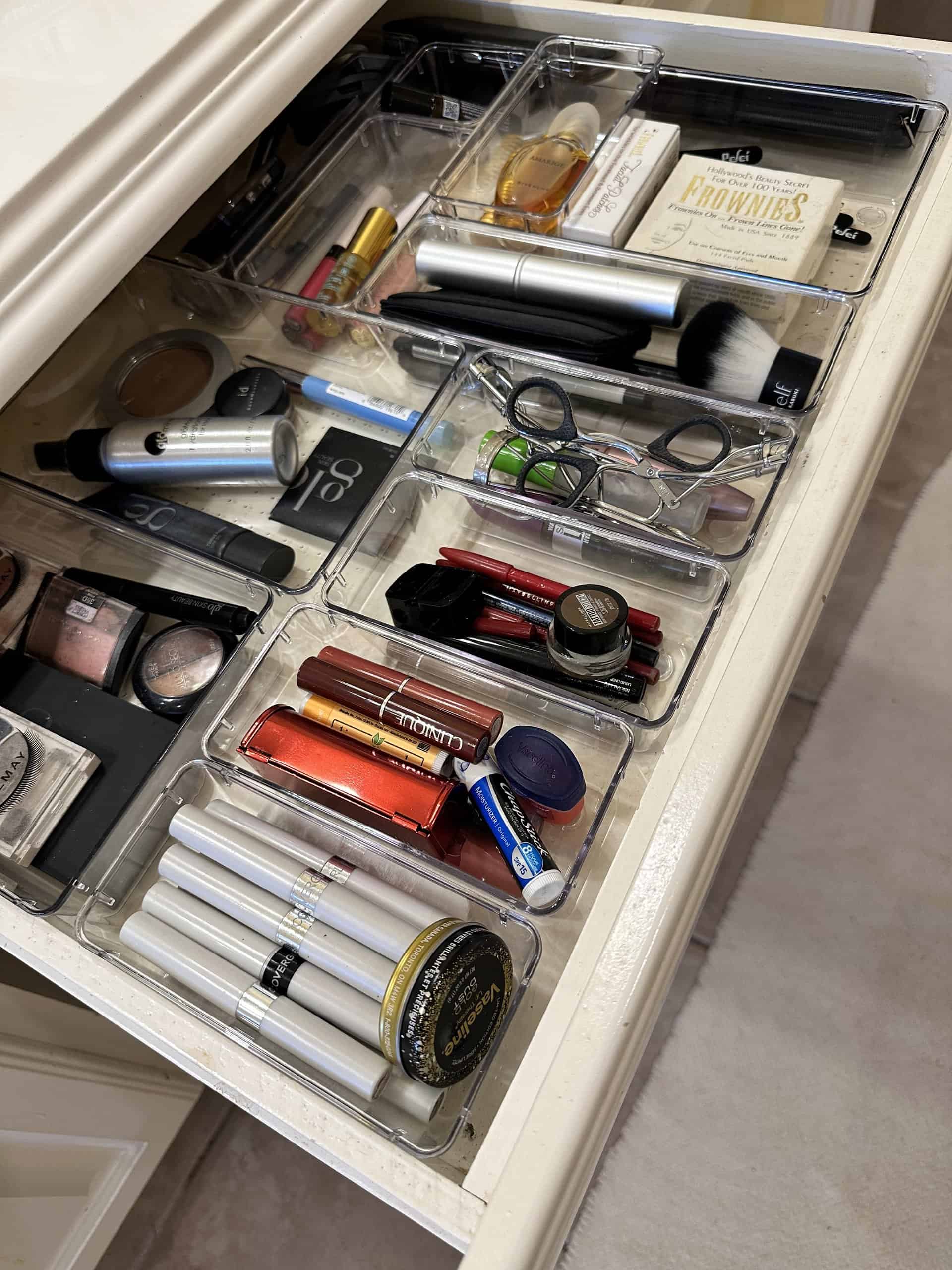 Neatly organized makeup and skincare products in clear acrylic drawers, showcasing beauty essentials and cosmetics storage solutions for a clean and efficient beauty routine.