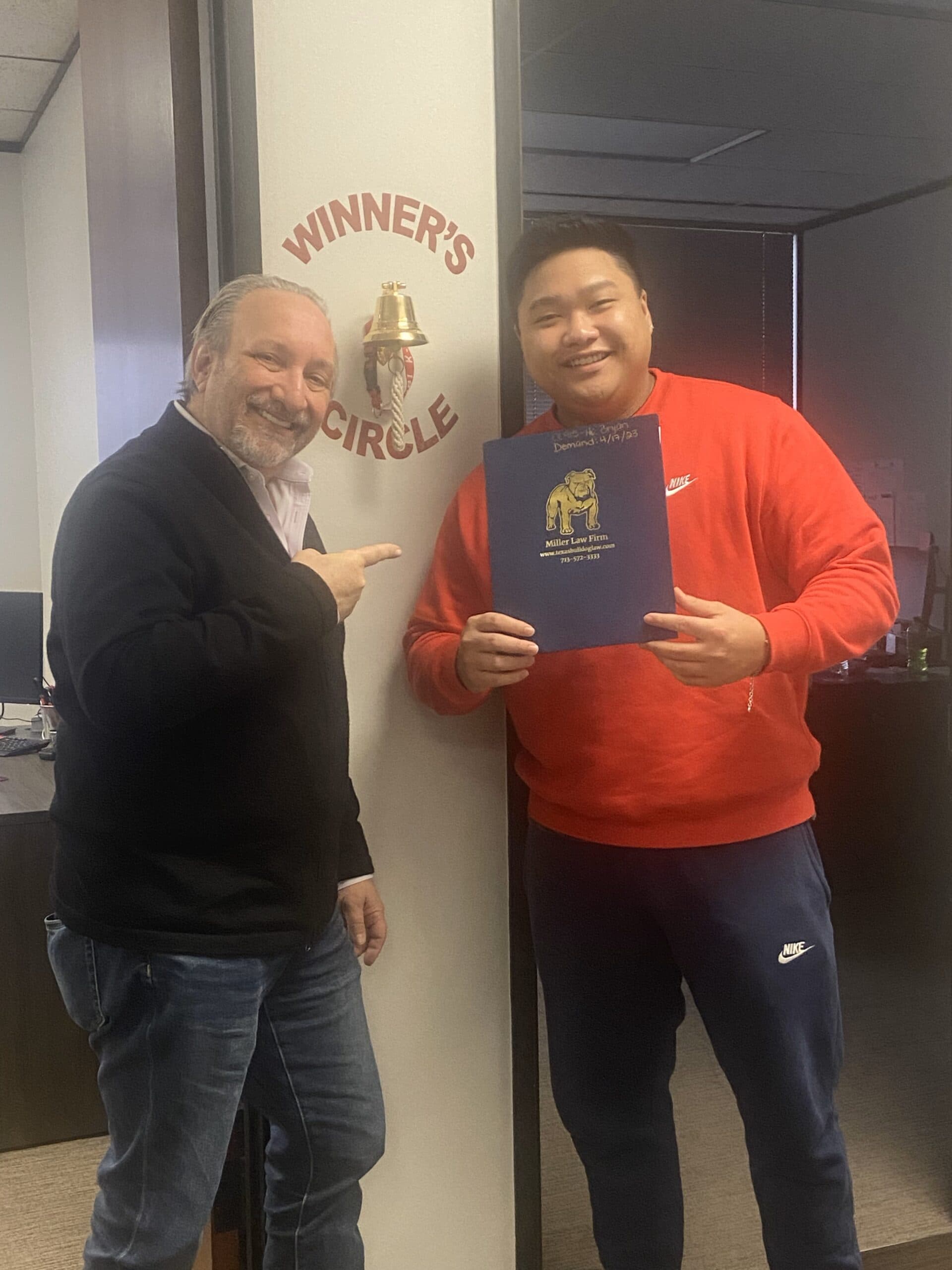 Client proudly poses at The Texas Bulldog Law Firm after personal injury settlement.