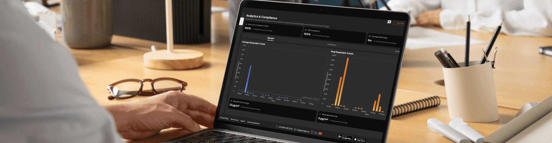 HSE manager analyzes dust exposure and compliance trends in the Dustlight web app on a laptop.