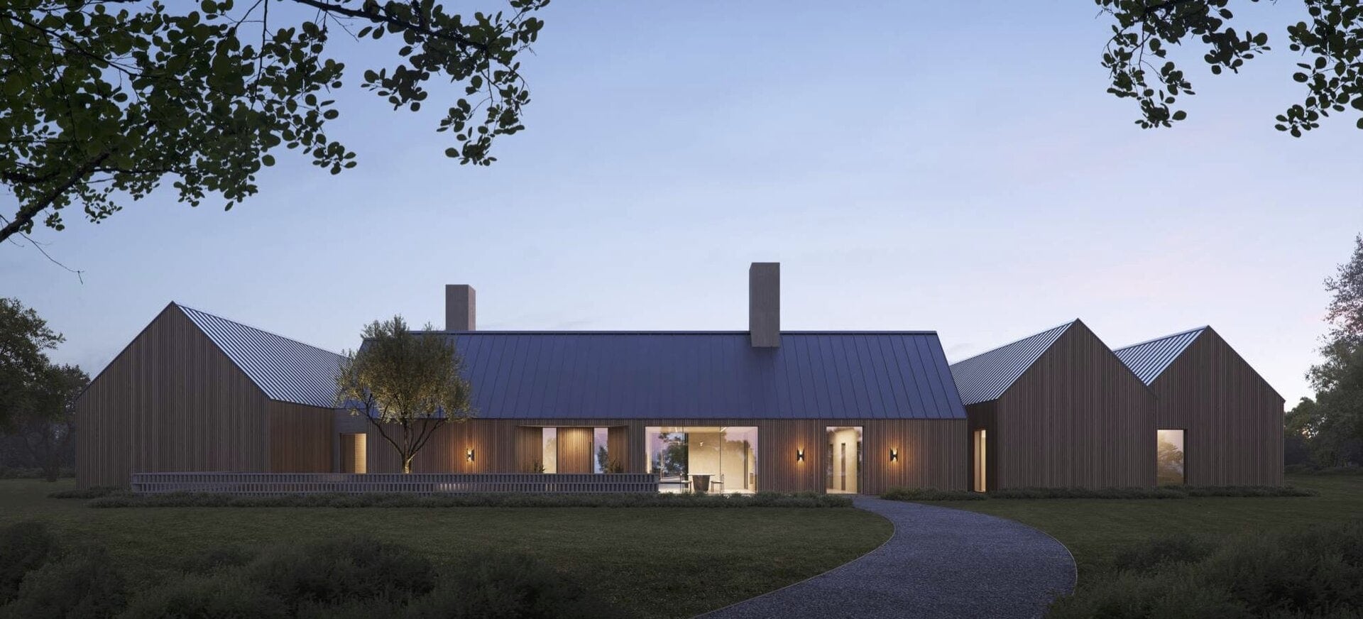 Modern residential house with vertical wood siding and metal roof at dusk.