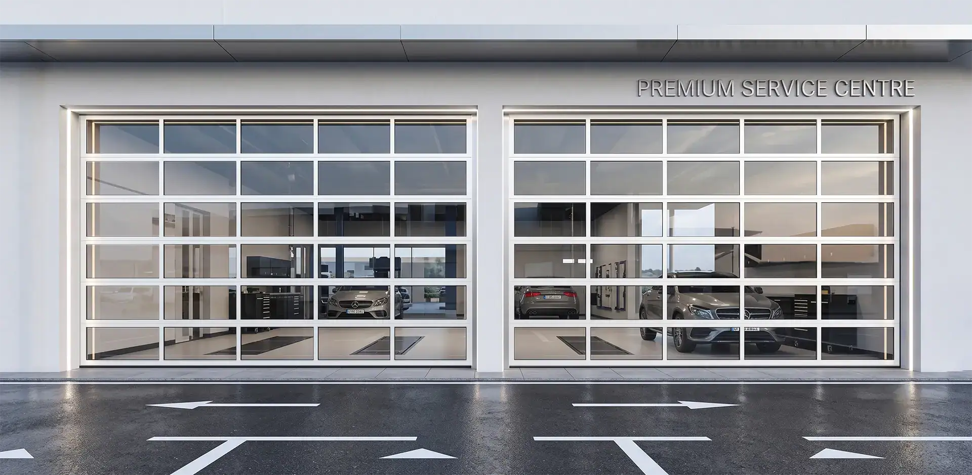 Full-view aluminum commercial sectional doors installed at a modern auto dealership service center, maximizing natural light and visibility.