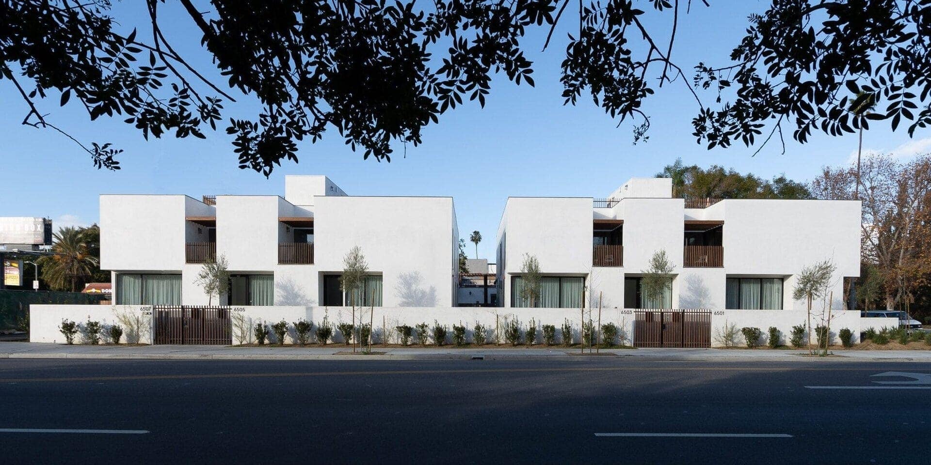 Contemporary residential townhouses with modern minimalist design and clean white facades.