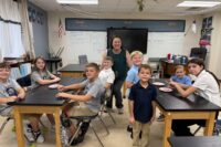 Christian character education in Joplin — Martin Luther School students working with their Faith Family leader during a Friendzy lesson