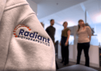 Close up image of the Radiant Biotherapeutics logo embroidered on the arm of a sweater