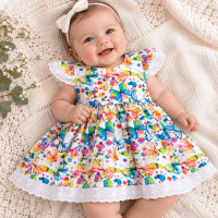 Baby Girl wearing the SIZE 00 baby tea party dress with colourful butterfly print and lace trim