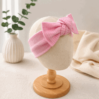 Chunky Knot Baby Headband in Pink on display