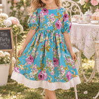 Girl wearing the size 4 blue bows and roses sage dress