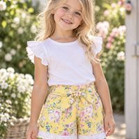 Girl wearing SIZE 4 lemon Roses belted Shorts