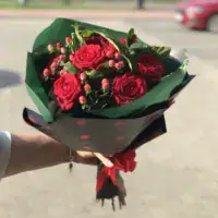 Elegancki bukiet z czerwonych róż i owoców hypericum