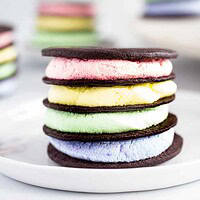 stacks of icebox cupcakes with pastel whipped cream and chocolate cookies