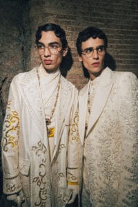 Two male models in ivory embroidered suits with baroque details and glasses – Dolce & Gabbana Alta Sartoria 2025.