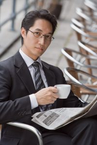 Businessman with coffee and newspaper