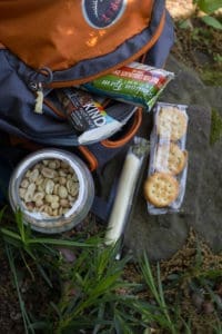 the best road trip snacks and hiking snacks: KIND bars, peanut butter crackers, and string cheese