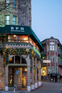 Charming Basin Park Hotel in Eureka Springs with festive holiday decorations and historic architectu.