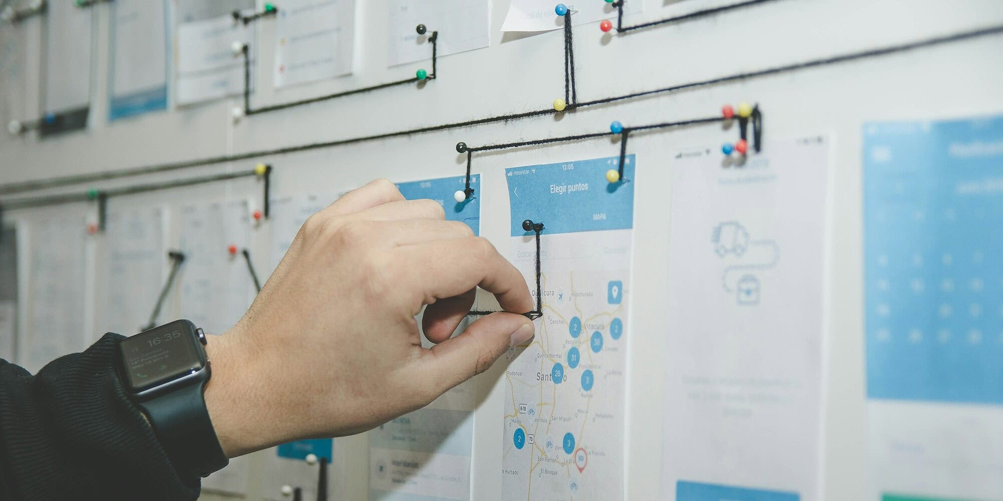 IT project estimates — person working on blue and white paper on board