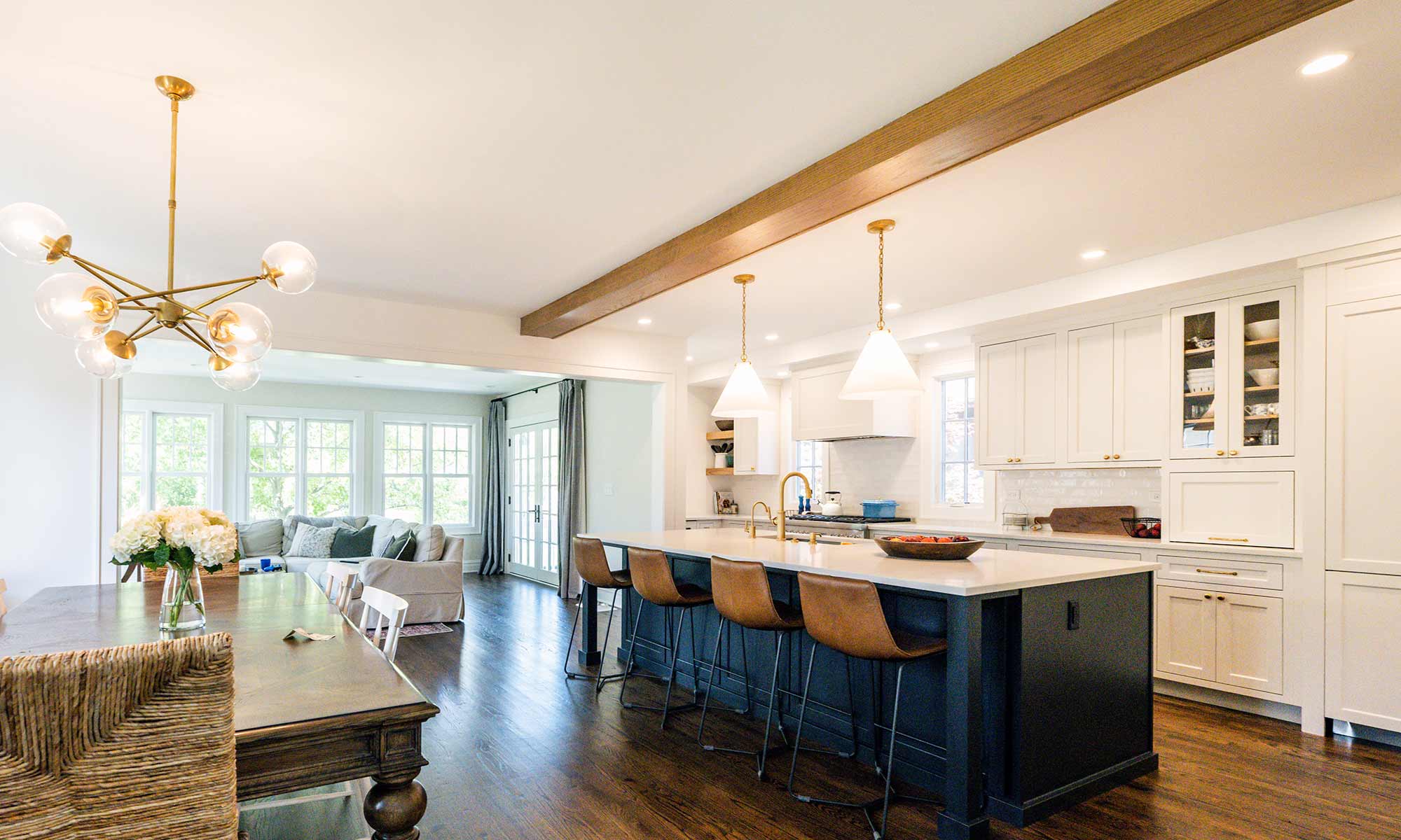 Luxury remodel and kitchen island with white and blue cabinets and white quartz countertops