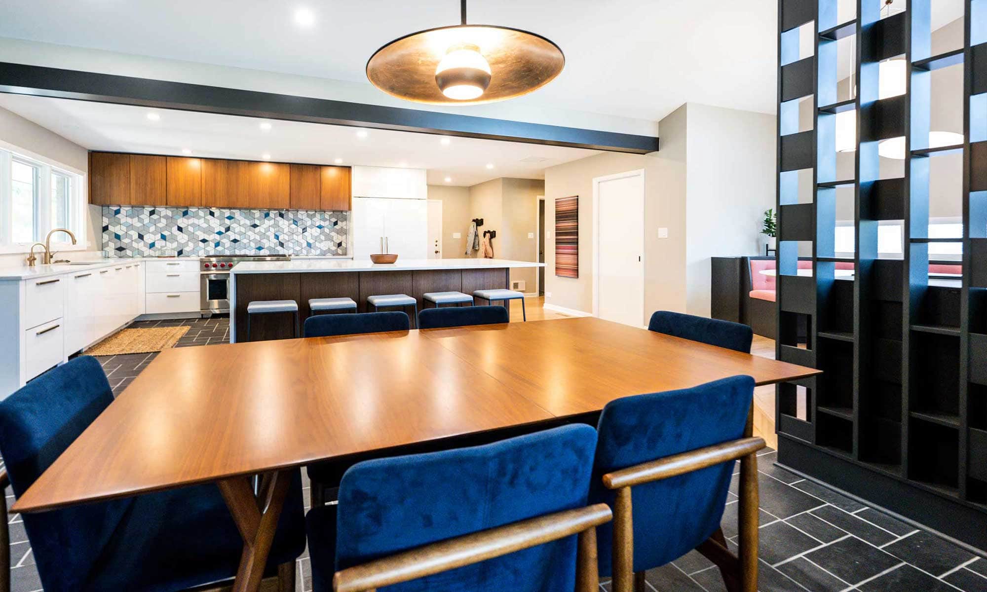 view of dining area and kitchen beyond in luxury mid-century remodel