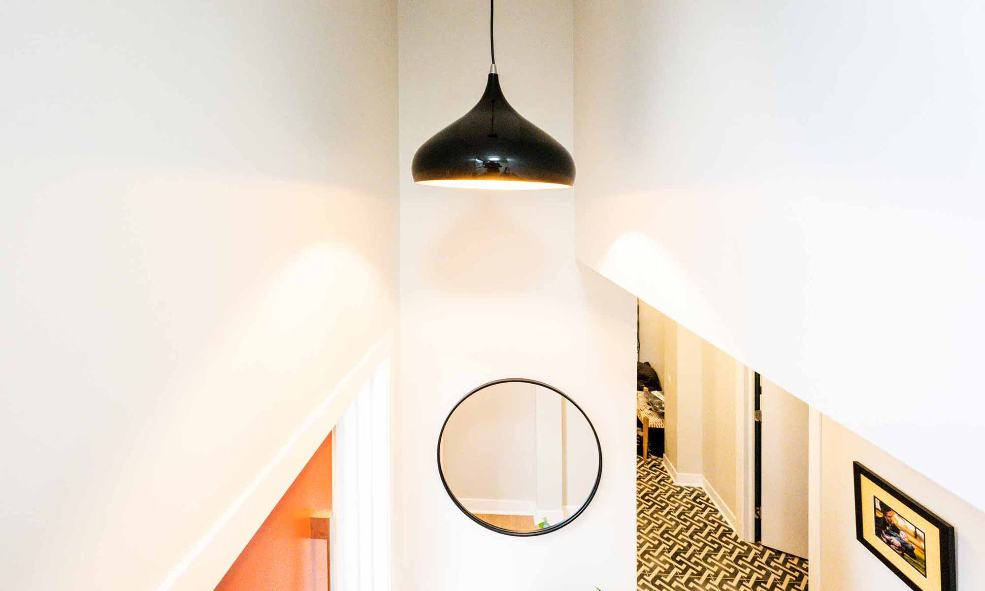 View of entrance hall and modern orange door in luxury second floor addition