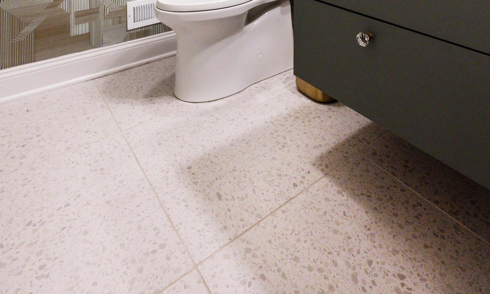 Luxury powder room remodel in Indian Head Park with textured geometric wallpaper and terrazzo flooring