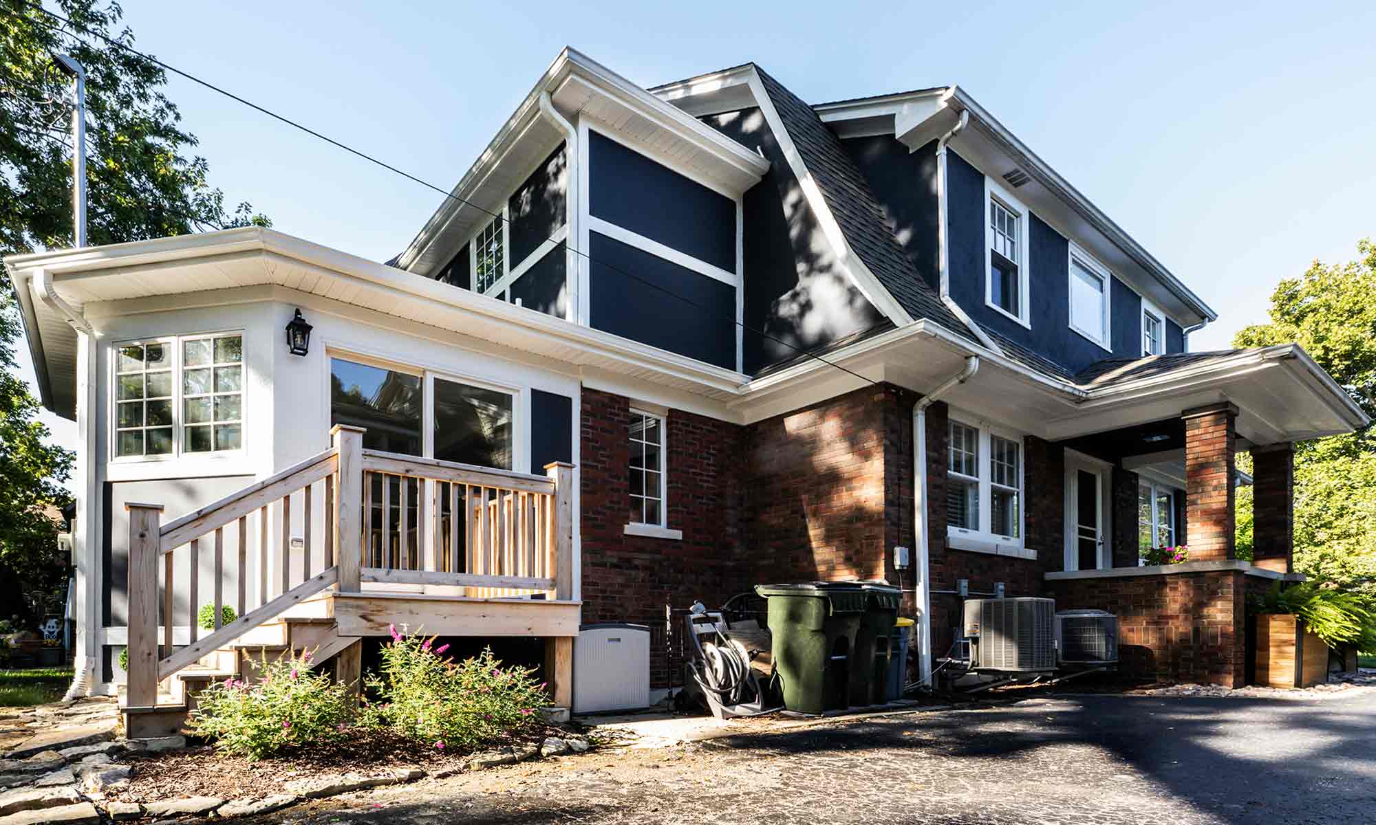 home addition with red brick and blue and white siding and trim