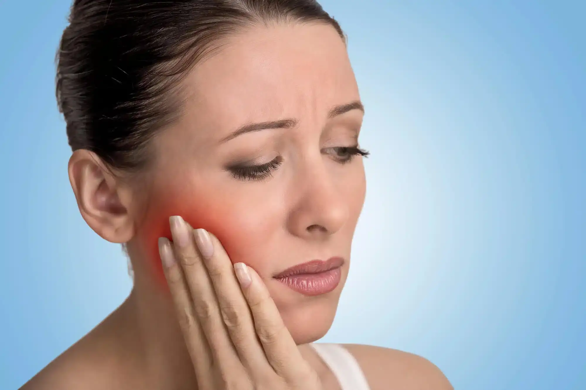 Woman experiencing tooth sensitivity before root canal treatments in Riverview, MI
